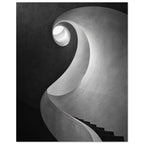 Spiral staircase viewed from below, with curved textured walls, dark steps and a bright opening in black and white.