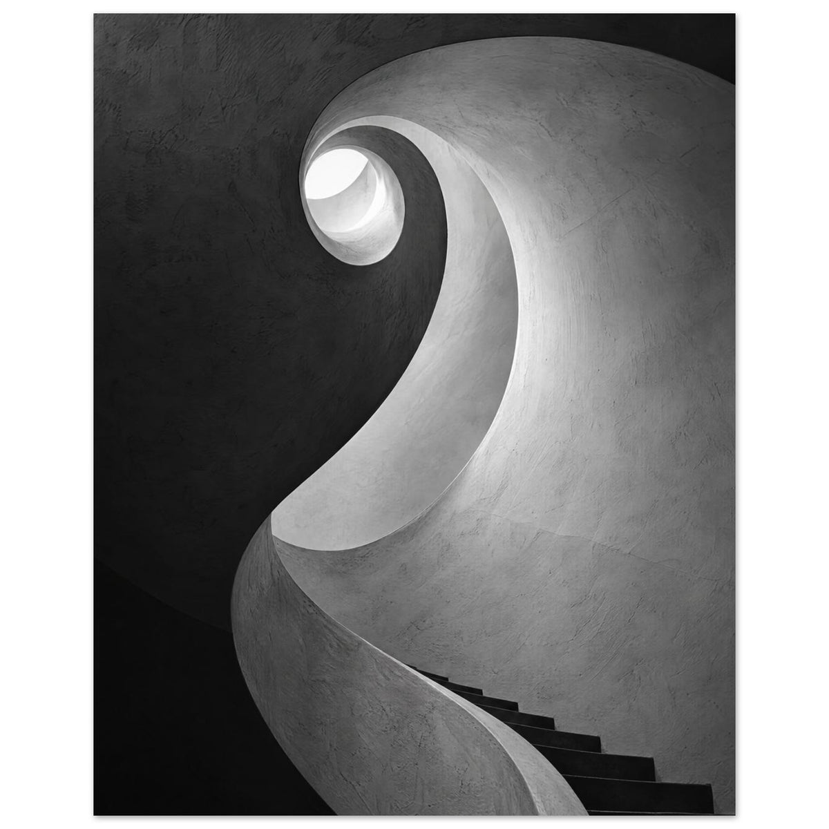 Spiral staircase viewed from below, with curved textured walls, dark steps and a bright opening in black and white.