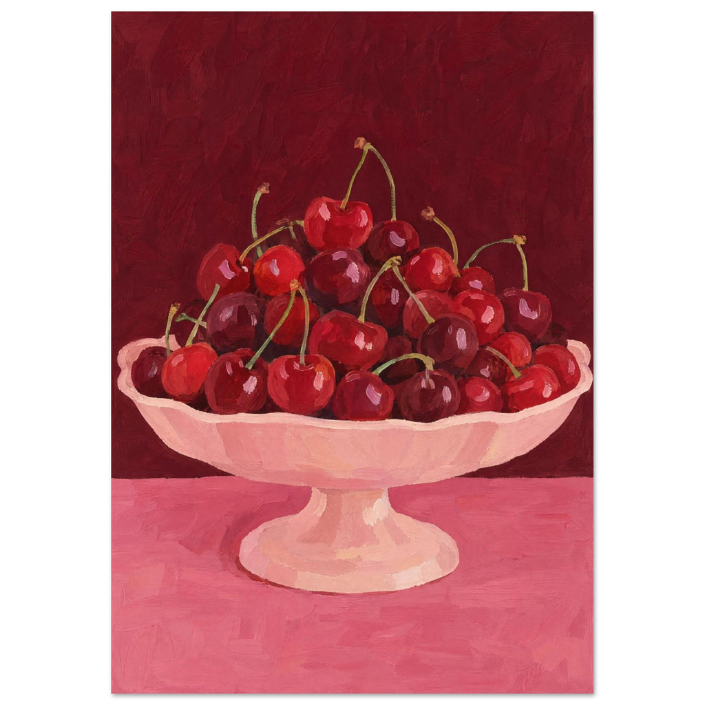 Red and burgundy cherries in a pale pink pedestal bowl on a pink tabletop against a deep red painted background.