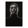 Black and white portrait of a woman with closed eyes, slicked-back hair and a dark high-neck top against black.