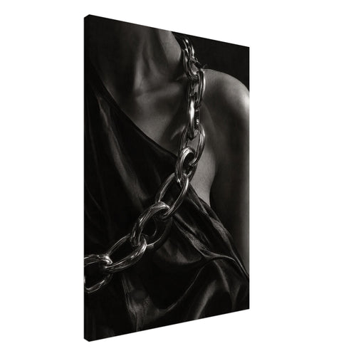 Oversized polished chain links cross dark, lustrous fabric beside a bare shoulder and neckline in black and white.