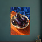 Purple aubergines in a shallow cream bowl on an orange surface, with folded blue fabric and bold visible brushstrokes.