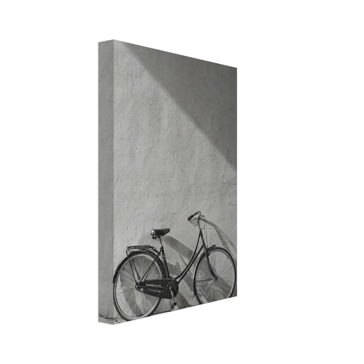 Bicycle leaning against a textured wall, with diagonal sunlight and long shadows across the wall and pavement.