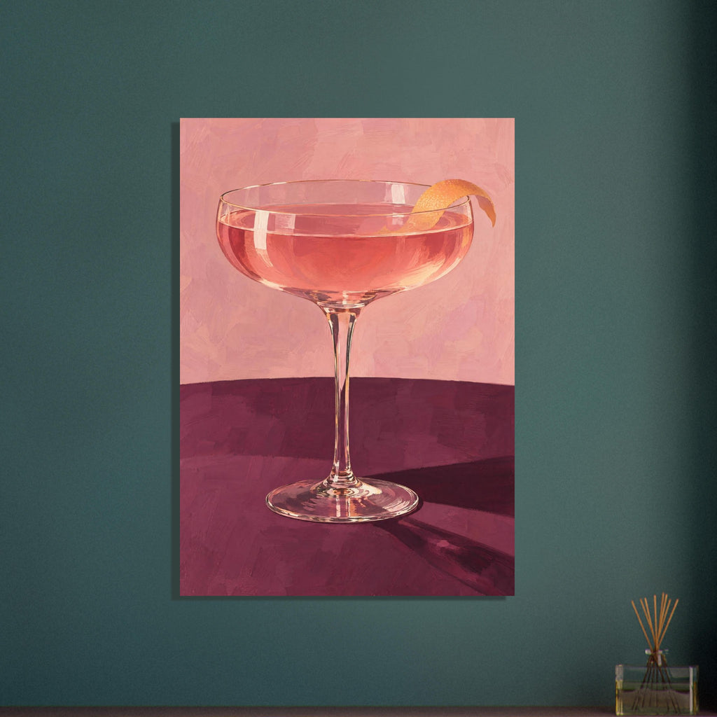 Coupe glass holding a pink cocktail with orange peel on a burgundy table against a textured pink background.