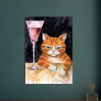 Ginger cat with green eyes resting its white paws on a golden table beside a tall glass of pink liquid, on black.