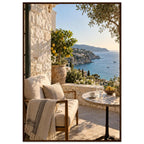 Lemon tree on a stone terrace with a cushioned chair, round table and blue sea overlooking a rocky coastline.