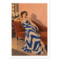Woman in a blue and cream striped dress reclining on a rust chaise longue against a peach wall beside a lit mirror.