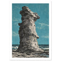 Tall, craggy grey rock stack on a rocky shore, with waves behind it and a teal sky under a distressed texture.