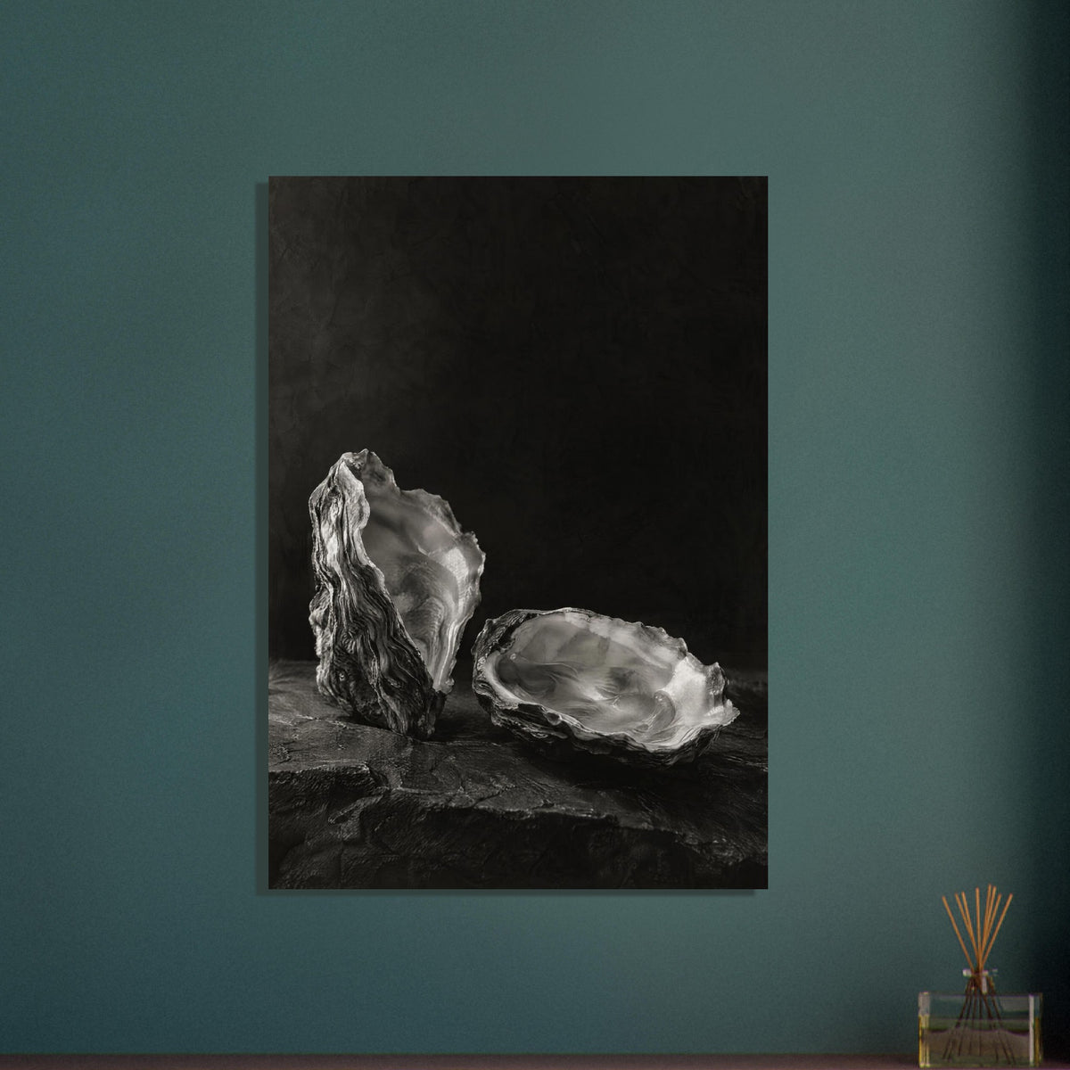 Oyster Light, two open oyster shells on dark slate with pale interiors and sharply lit ridges beneath a broad area of shadow.