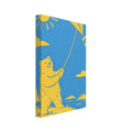 Yellow bear flying a kite beneath a sun and clouds, beside blue water with tree-lined banks, in a paper-cut style.