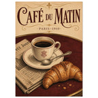 Coffee cup, croissant, spoon and newspaper on a burgundy table beneath decorative Café du Matin and Paris 1910 lettering.