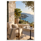Lemon tree on a stone terrace with a cushioned chair, round table and blue sea overlooking a rocky coastline.
