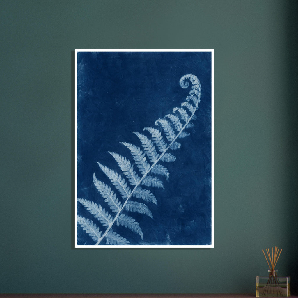 Pale blue fern frond with a curled tip extending diagonally across a textured deep blue background.