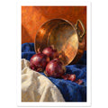 Three red onions and loose skins on blue and cream cloth beside a tilted copper pan against an orange background.