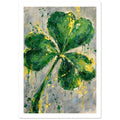 Four leaf clover painted in layered greens with yellow splashes and paint drips on a mottled grey and cream background.