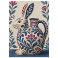 Rabbit-shaped jug decorated with blue leaves and burgundy flowers, surrounded by floral stems on a cream background.