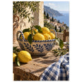 Lemons in a blue-and-white bowl on a wooden table, with olive branches, checked cloth and a coastal village beyond.