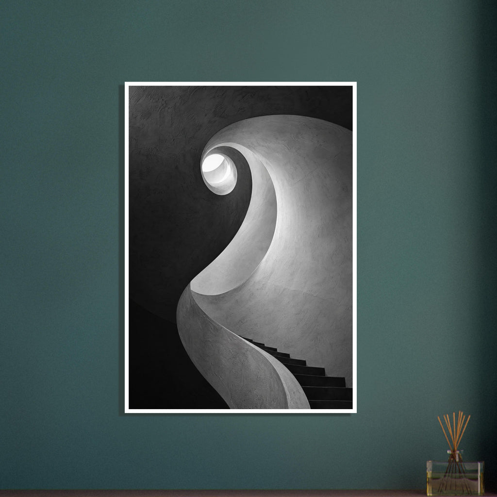 Spiral staircase viewed from below, with curved textured walls, dark steps and a bright opening in black and white.