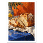 Sliced crusty loaf on cream cloth over a blue table, with lemons, pottery and olive branches against an orange backdrop.