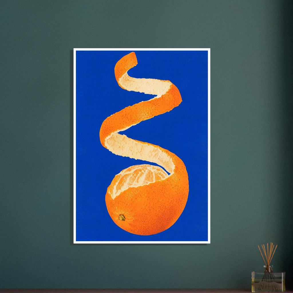 Partly peeled orange with a long spiral of orange rind and cream pith against a vivid cobalt-blue background.