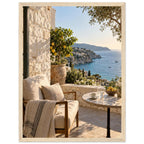Lemon tree on a stone terrace with a cushioned chair, round table and blue sea overlooking a rocky coastline.