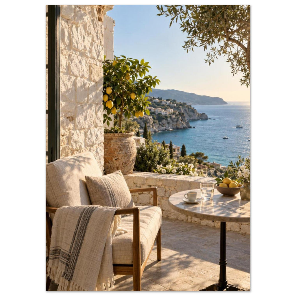 Lemon tree on a stone terrace with a cushioned chair, round table and blue sea overlooking a rocky coastline.