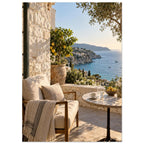 Lemon tree on a stone terrace with a cushioned chair, round table and blue sea overlooking a rocky coastline.