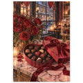 Red roses beside an open heart-shaped chocolate box on a marble counter, with candles and a snowy street beyond the window.
