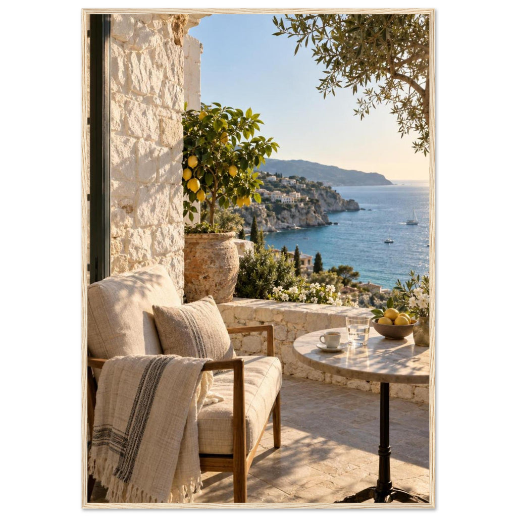 Lemon tree on a stone terrace with a cushioned chair, round table and blue sea overlooking a rocky coastline.