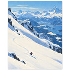Lone skier carving tracks down a snowy slope above a blue lake, forested valleys and distant snow-covered mountains.
